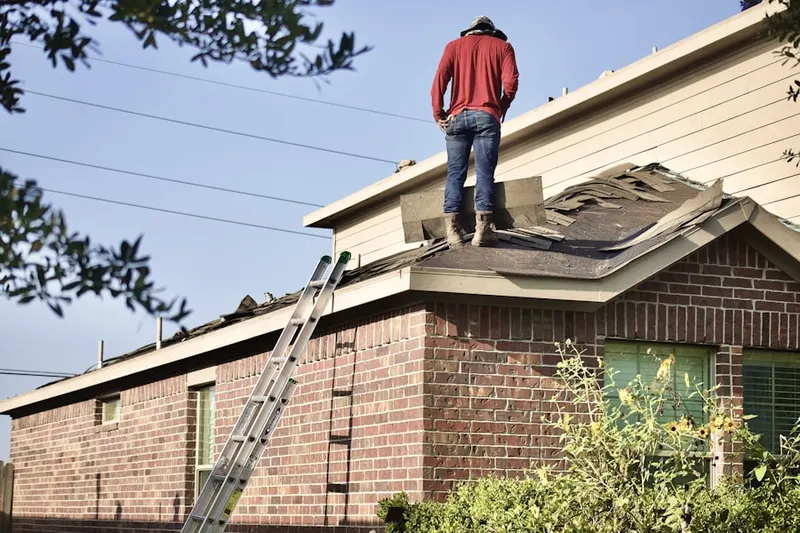 Professional roofer working on a residential roof in Boring